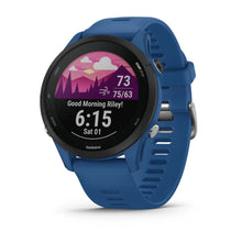 Garmin Forerunner 255 smartwatch with a blue strap displaying a colorful morning greeting and fitness metrics on the screen.