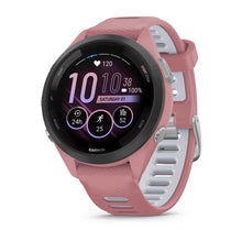 Garmin Forerunner 265S smartwatch displayed with a pink and white strap, showing heart rate, time, and various fitness metrics on the screen.
