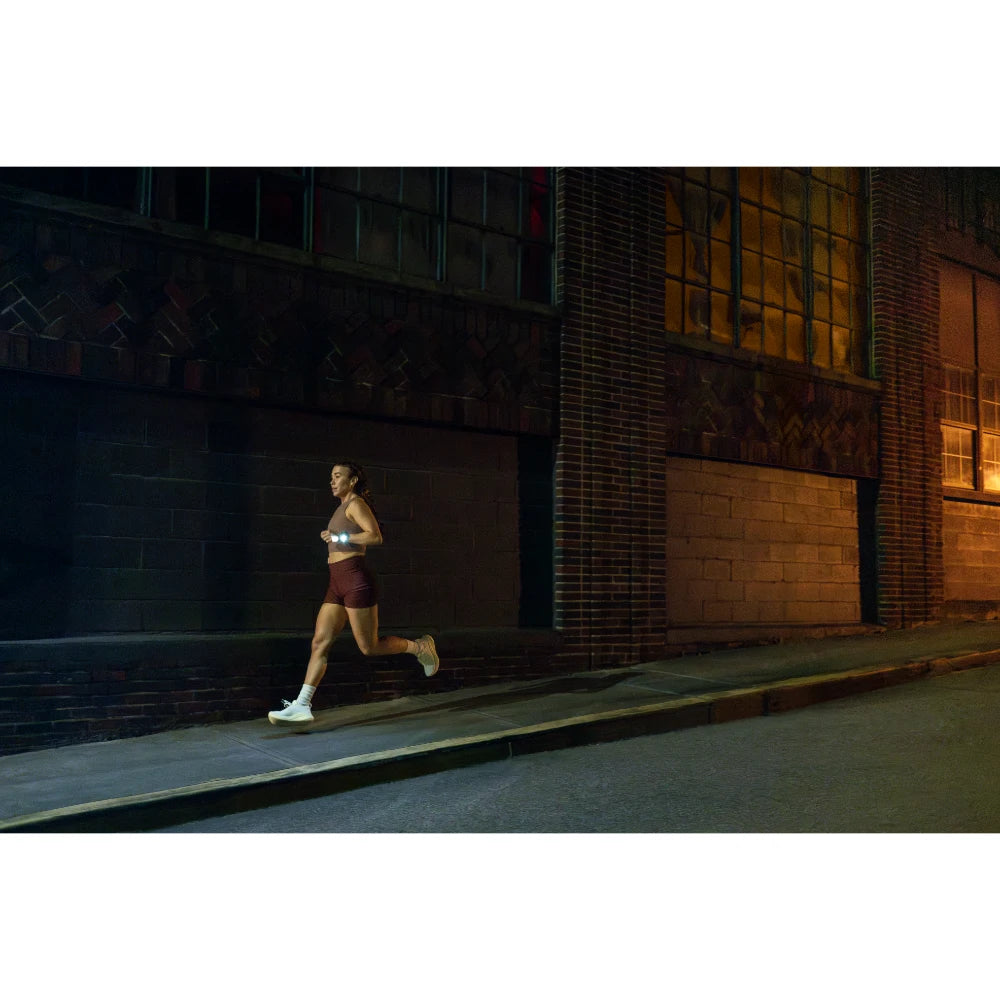 Garmin Forerunner 970 lifestyle – runner checking watch mid-stride