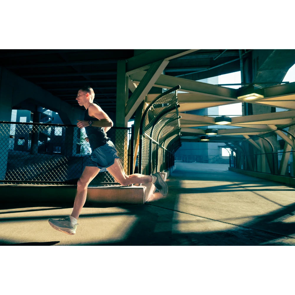 Garmin Forerunner 970 lifestyle – woman running with stats on screen