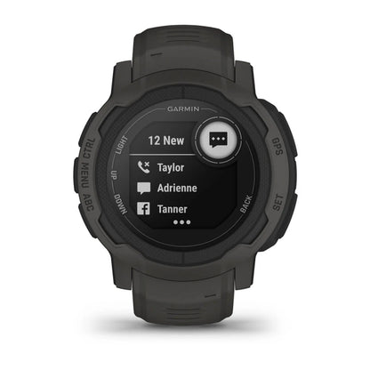 A Garmin smartwatch displaying a notification screen with four new messages, showing contacts named Taylor, Adrienne, and Tanner, against a dark background. The watch has a rugged design and a green strap.