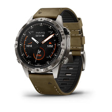 Garmin MARQ Adventurer (Gen 2) smartwatch featuring a black dial with orange accents and a two-tone strap, displayed at an angle.