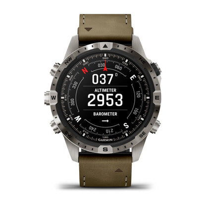 Garmin MARQ Adventurer (Gen 2) smartwatch displaying altimeter and barometer readings with a metal bezel and olive green leather strap.