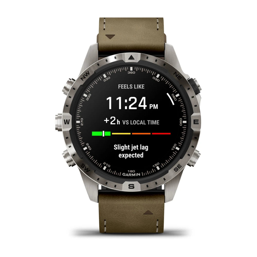 Garmin MARQ Adventurer (Gen 2) smartwatch displaying the time 11:24 PM, indicating a +2 hour difference vs local time and a message about slight jet lag expected.