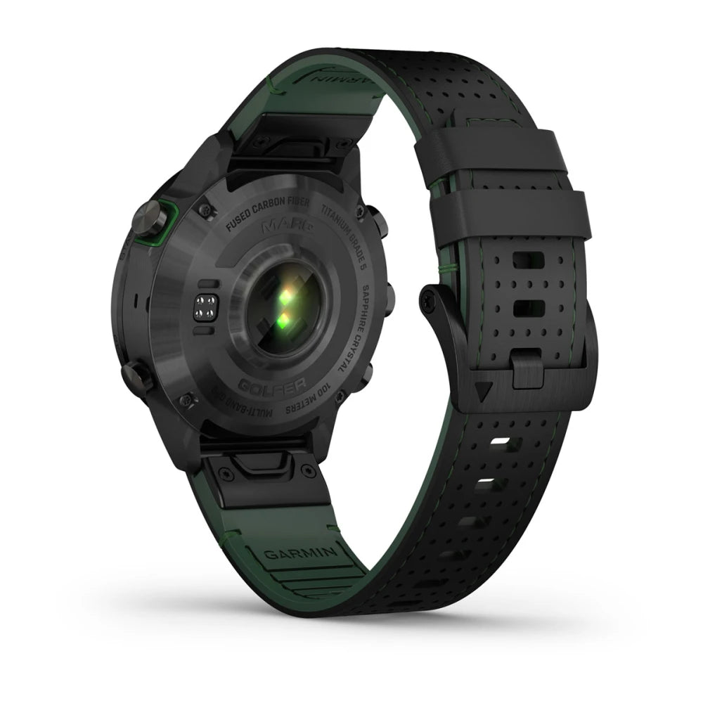 Garmin MARQ Golfer (Gen 2) Carbon Edition smartwatch showing the back view, featuring a black and green design with a sapphire lens and heart rate sensor.