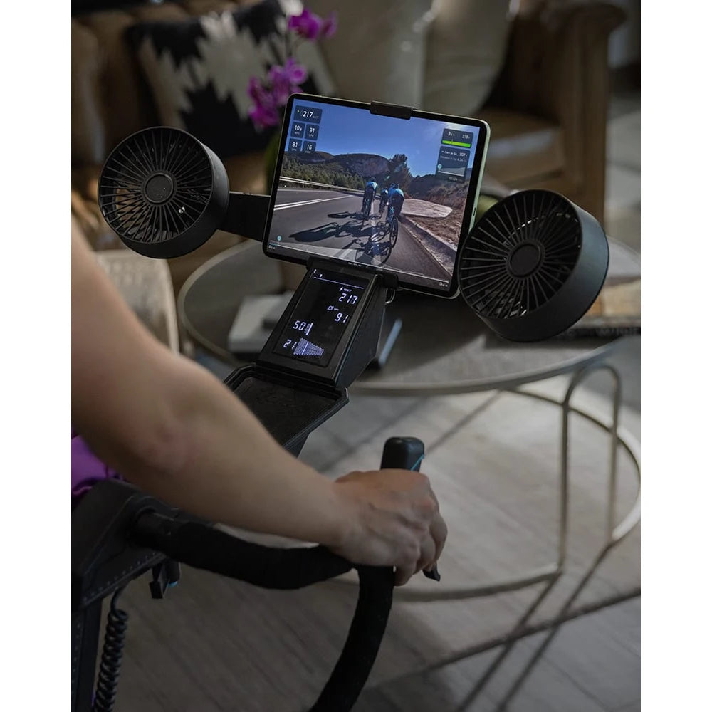 Indoor cycling setup with ProForm exercise bike and attached tablet showcasing virtual race.