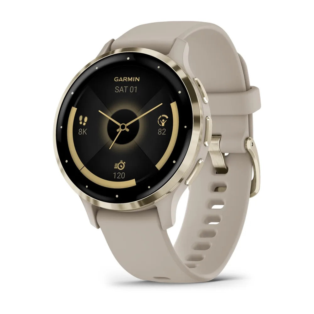 Garmin Venu 3S smartwatch with a round face, gold accents, and a light beige strap, displaying the date and various fitness metrics.