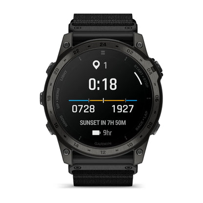 Garmin tactix 7 AMOLED Edition smartwatch displaying time, location, and sunset information on a dark screen with a black strap.