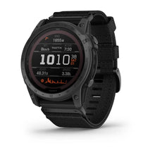 Garmin tactix 7 Pro Ballistics Edition smartwatch displaying various metrics on its screen, including range, elevation, and wind direction, with a black strap.