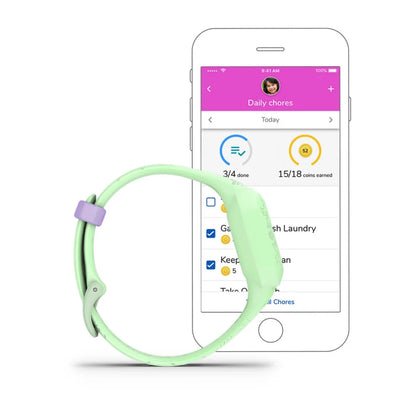 Garmin vívofit jr. 3 fitness tracker displayed next to a smartphone showing the daily chores and rewards app interface.