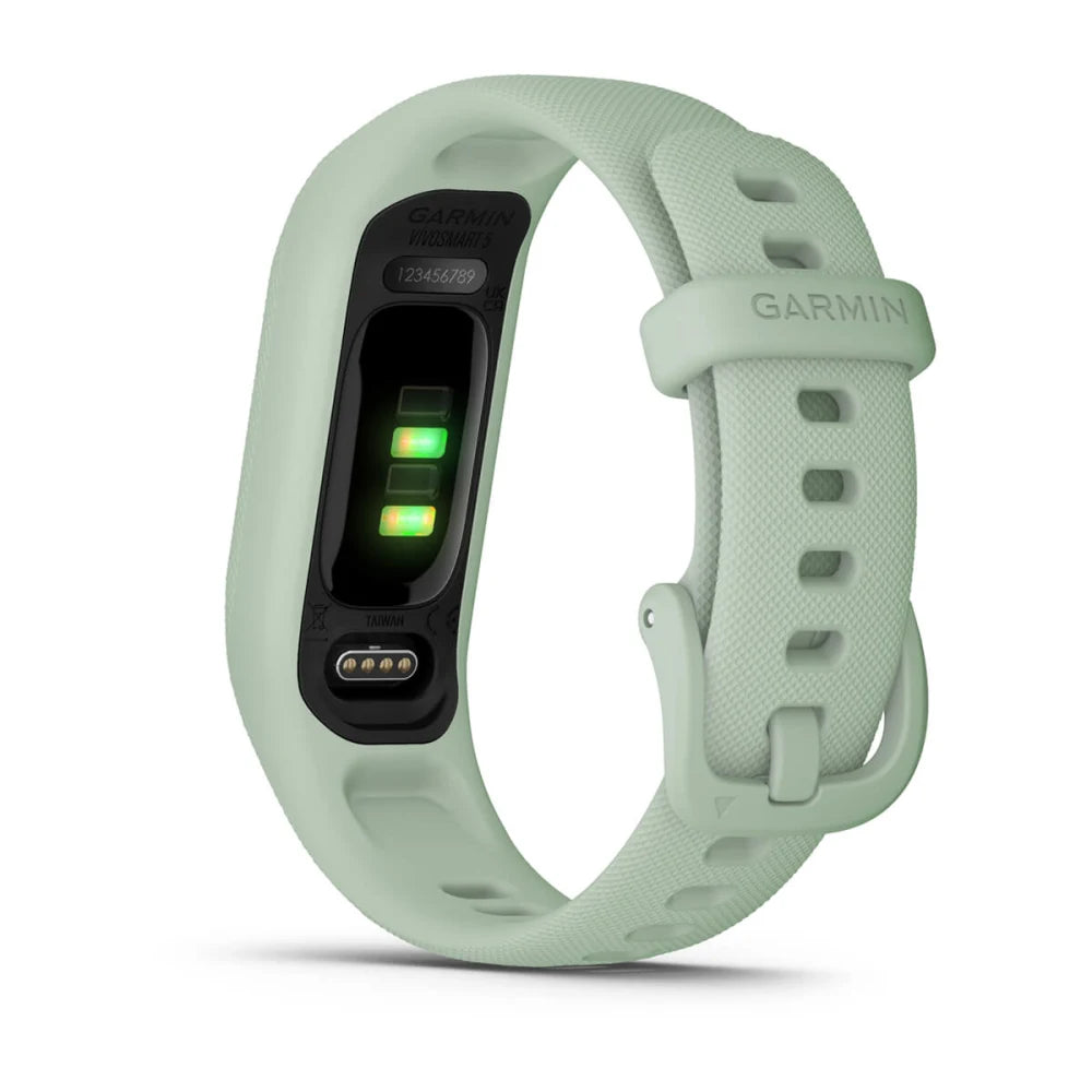 Garmin vivosmart 5 fitness tracker in light green color, showcasing heart rate sensors and charging contacts.
