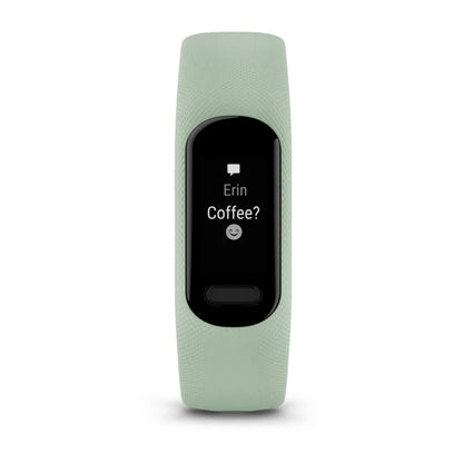 Garmin vivosmart 5 fitness tracker displaying a message from Erin asking 'Coffee?' with a smiley face on a black screen.