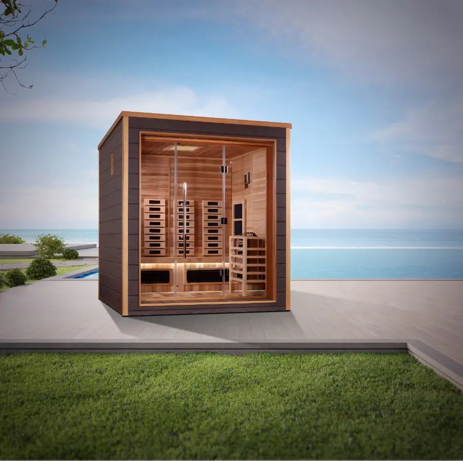 Compact 3-person wooden sauna with glass door by the ocean.
