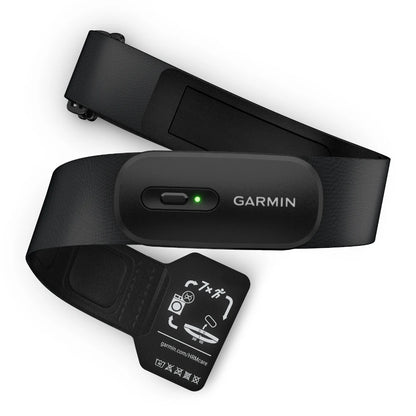 Garmin HRM 200 heart rate monitor with a black strap and an indicator light, featuring care instructions on a tag.