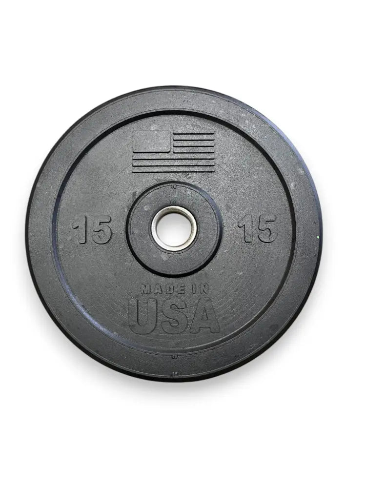 Black rubber bumper plate with 15 lb weight marking on each side, center hole, and "Made in USA" text embossed on the face.