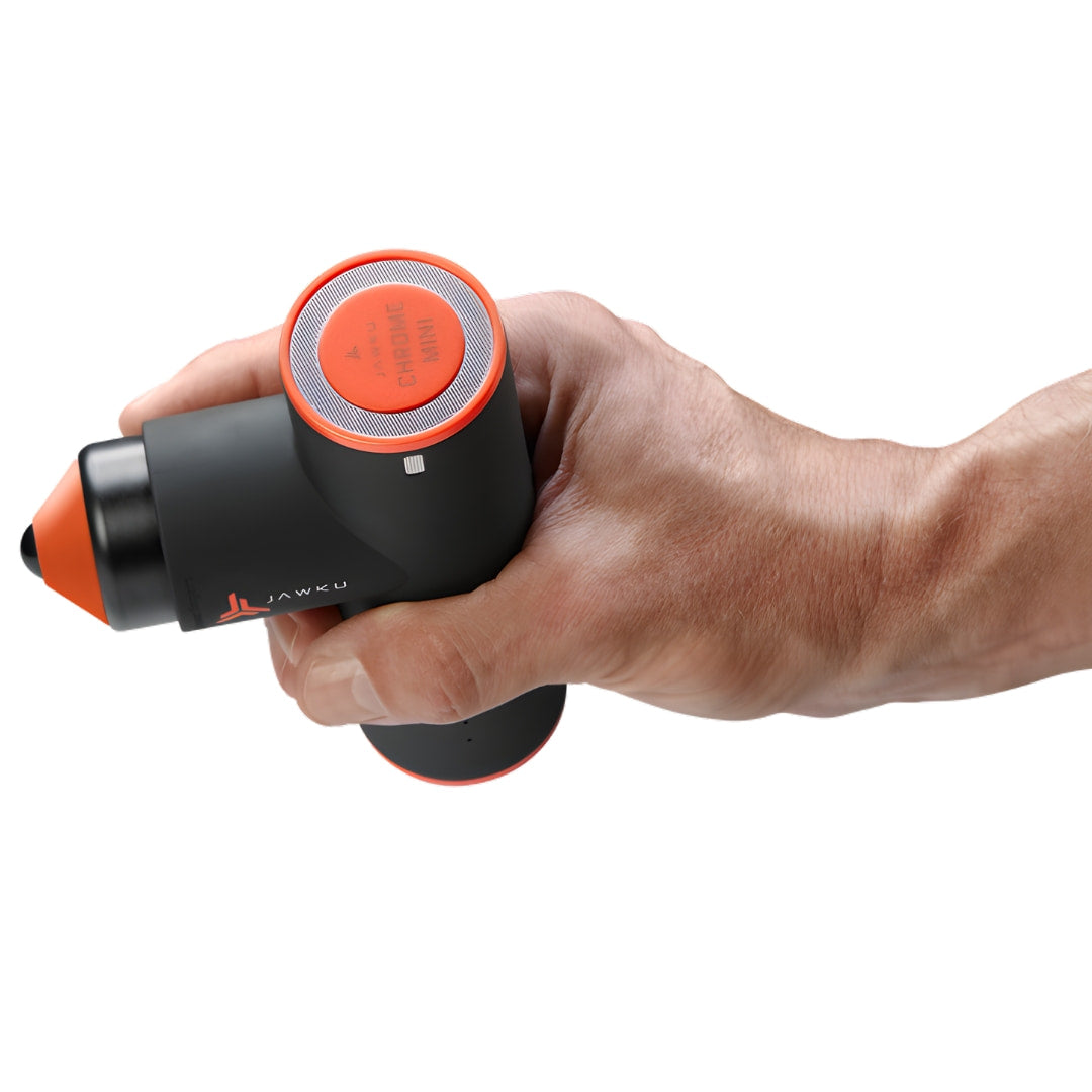 Jawku muscle massage gun in hand, black with orange accents, handheld recovery tool.