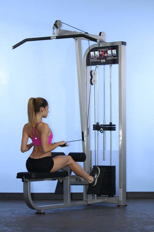 Woman using a seated row machine in a gym for back exercise, wearing pink sportswear.