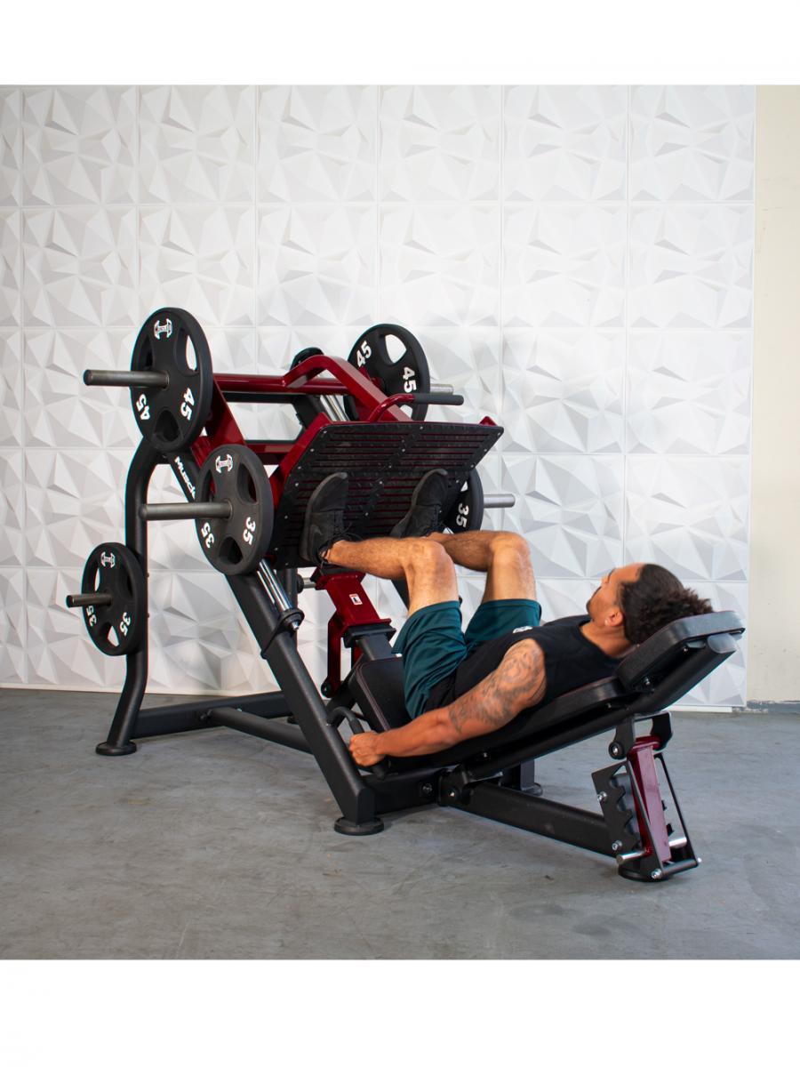 Man performing leg press on a multi-weight gym machine.