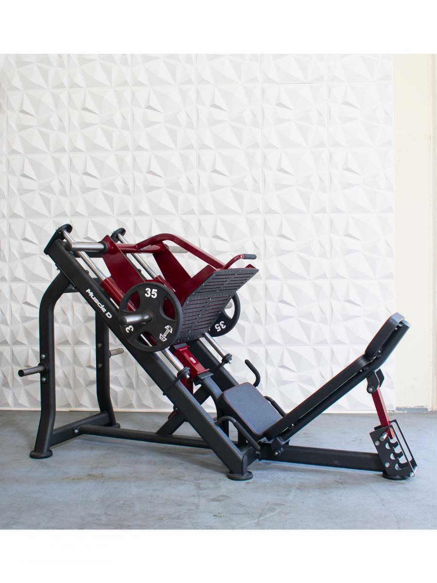 Leg press machine with black frame and red-weight plates.
