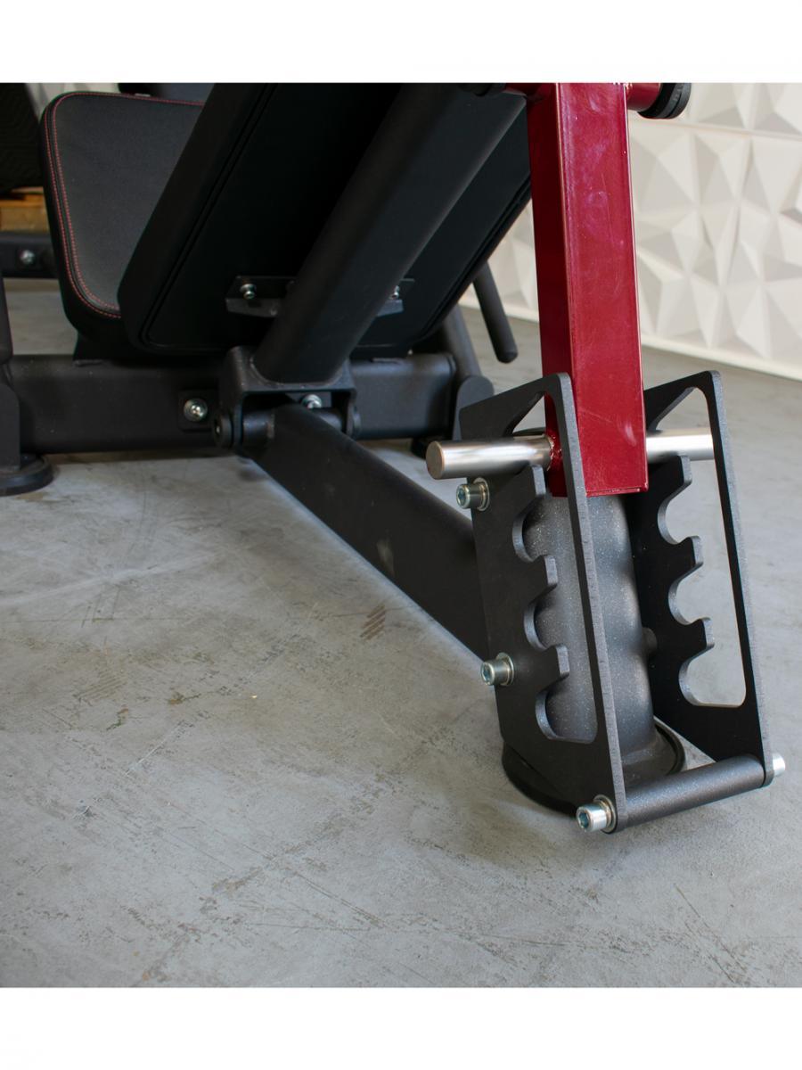 Close-up of a leg press machine with a red frame and black base.