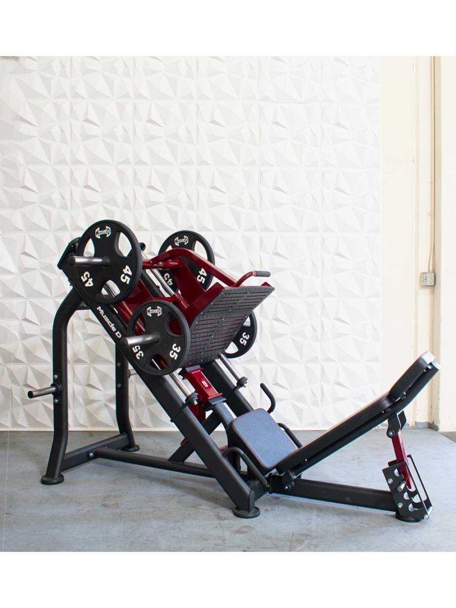 Leg press machine with weights in a gym setting.
