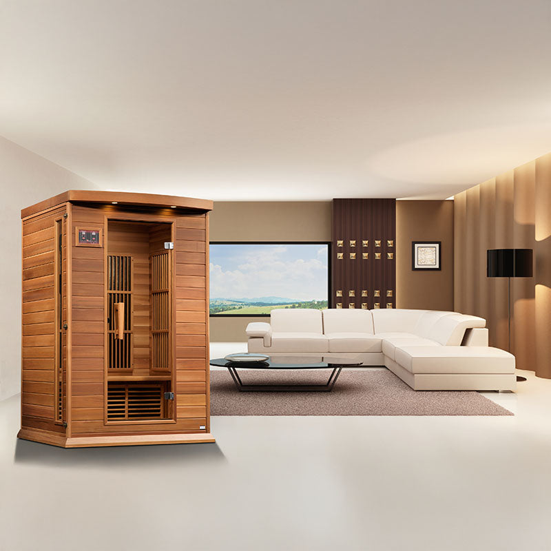 Maxxus MX-K206-01 Far Infrared Sauna displayed in a modern living room setting with a white sofa and large window.