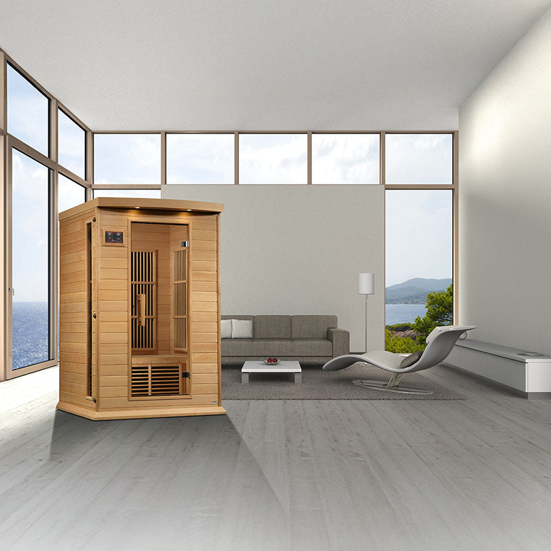 A modern interior featuring the Maxxus MX-K206-01 Far Infrared Sauna positioned in a spacious room with large windows and contemporary furniture.