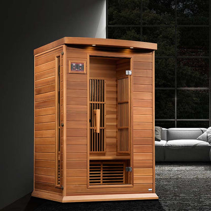 Maxxus MX-K206-01 Far Infrared Sauna featuring a wooden design, with an open door showcasing the interior and a modern living room setting in the background.