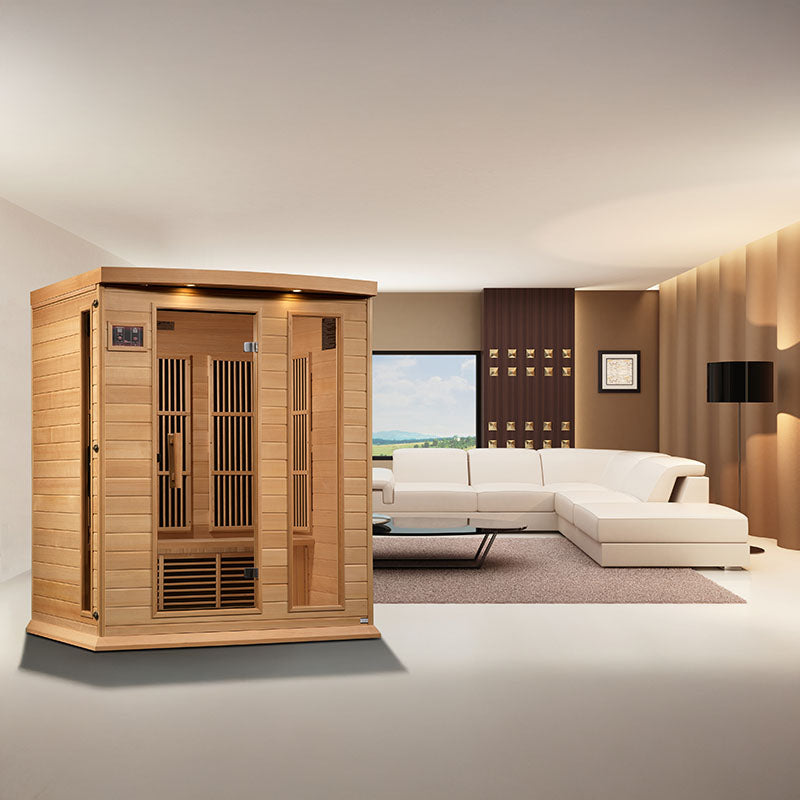 Maxxus MX-K306-01 Far Infrared Sauna positioned in a modern living room with a white sectional sofa and large windows.