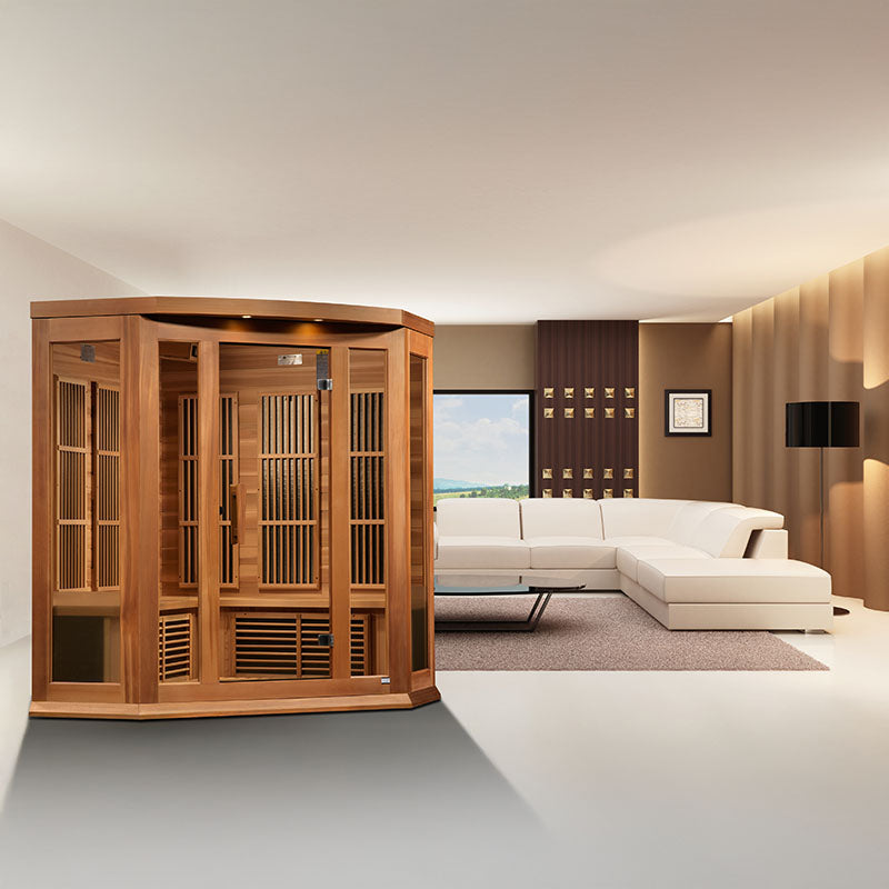 Maxxus MX-K356-01 Far Infrared Corner Sauna positioned in a modern living room setting with a white sofa and large window.