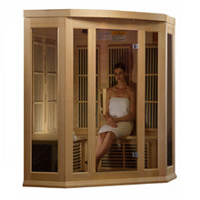 Maxxus MX-K356-01 Far Infrared Corner Sauna with a woman sitting inside, wrapped in a towel, showcasing the sauna's wooden design and glass panels.