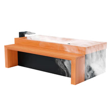 A modern bathtub featuring a wooden exterior with a sleek black base. The bathtub is filled with steam, creating a relaxing atmosphere.