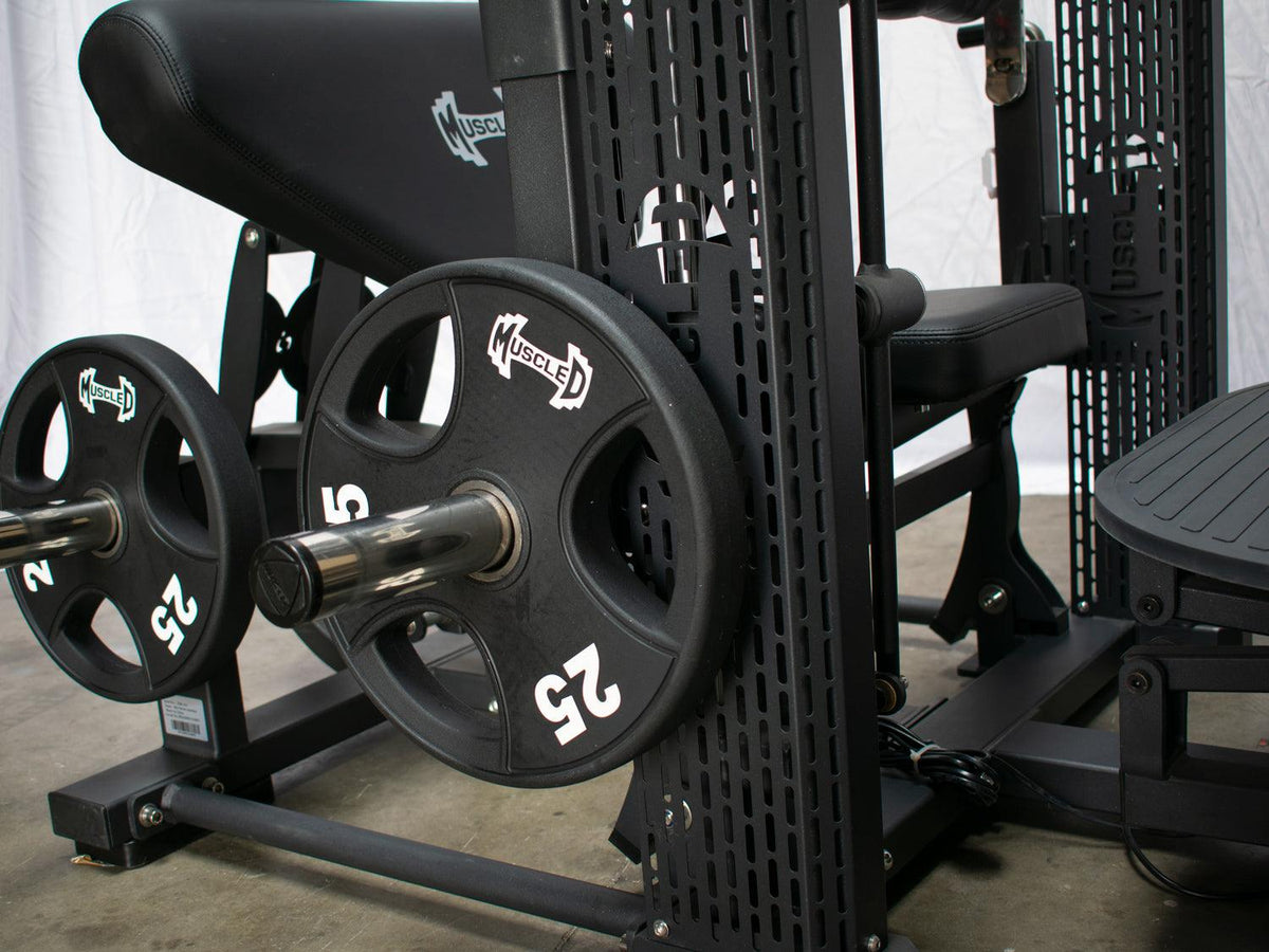Motorized hip thruster gym machine with weight plates and seat.