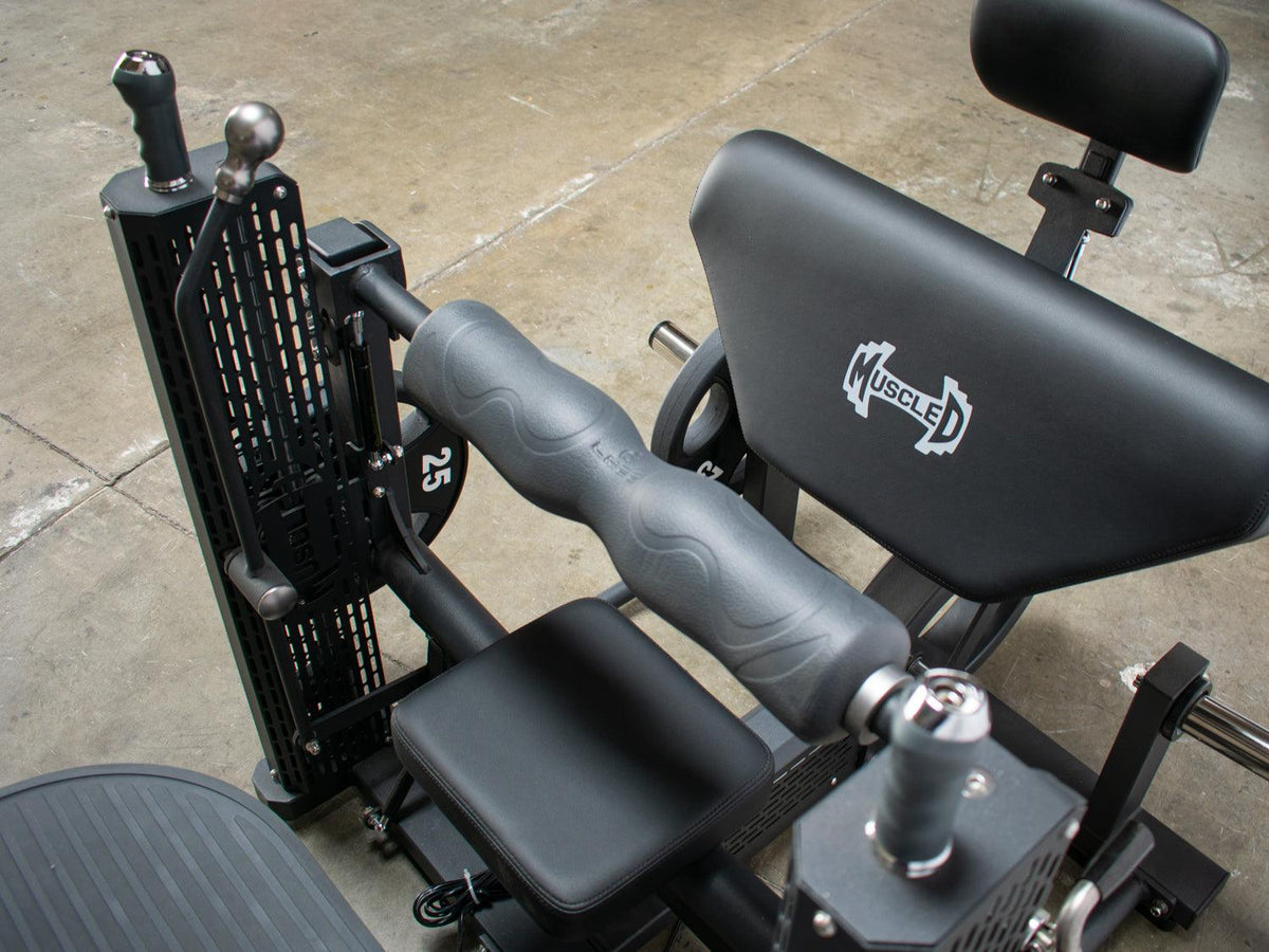 Close-up of a motorized hip thruster with padded seat and leg supports.