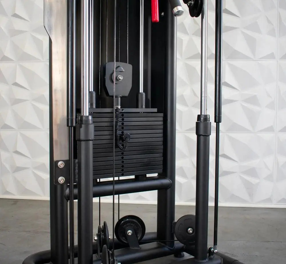 Black cable machine with dual weight stacks, adjustable pulleys, and chrome handlebar attachments on a textured white gym wall background.