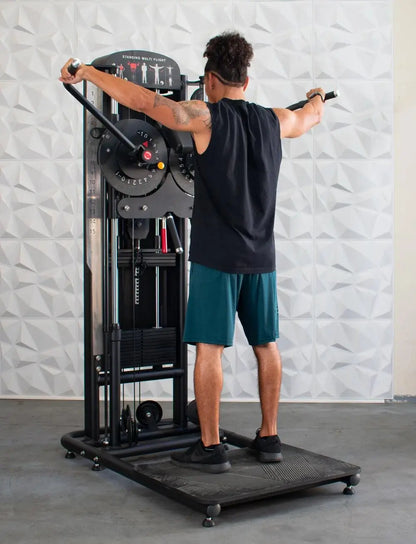Man performing a standing multi-flight exercise on a black cable machine with adjustable pulley system and weight stack, arms extended outward in a flying motion.