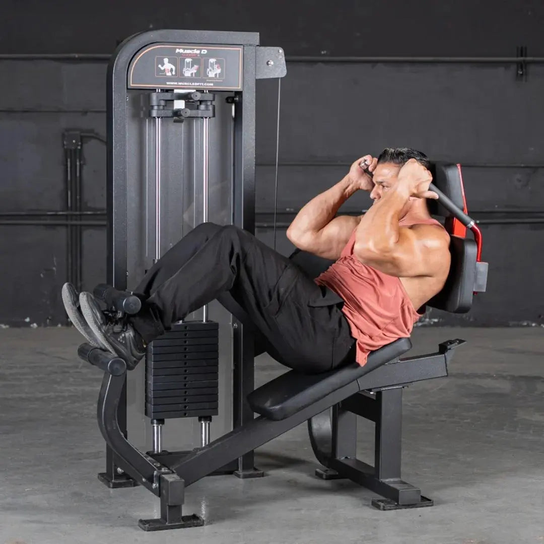 Man performing an abdominal crunch on a Muscle D selectorized crunch machine with black frame and weight stack in a gym setting.