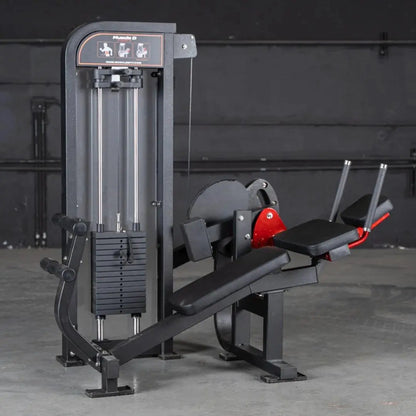 Commercial abdominal crunch machine with black frame, red accent details, dual chrome columns, and instruction panel at top in a gym setting.