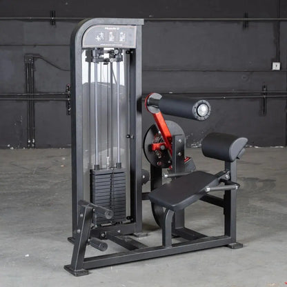 Commercial selectorized back and ab combo machine with gray and black frame, red accents, weight stack on left side, and padded seat and back support on right side in a gym setting.