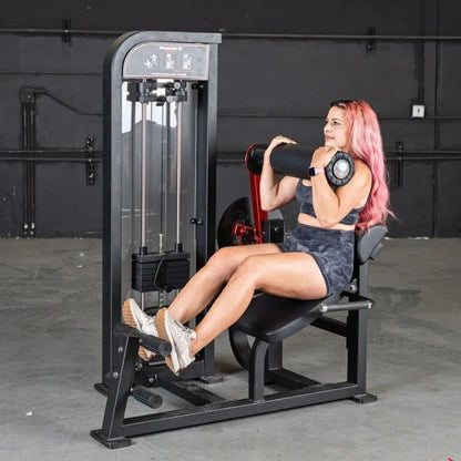 Woman performing a back and abdominal exercise on a black selectorized back and ab combo machine with instruction icons displayed on the top panel.