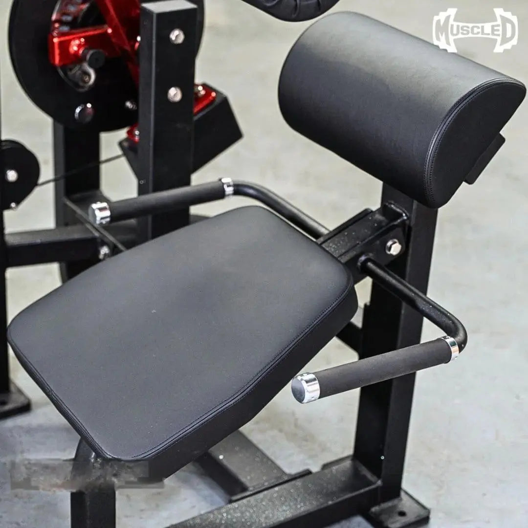 Black and red selectorized back and ab combo machine with padded seat, backrest, and leg extension attachment with chrome handles.