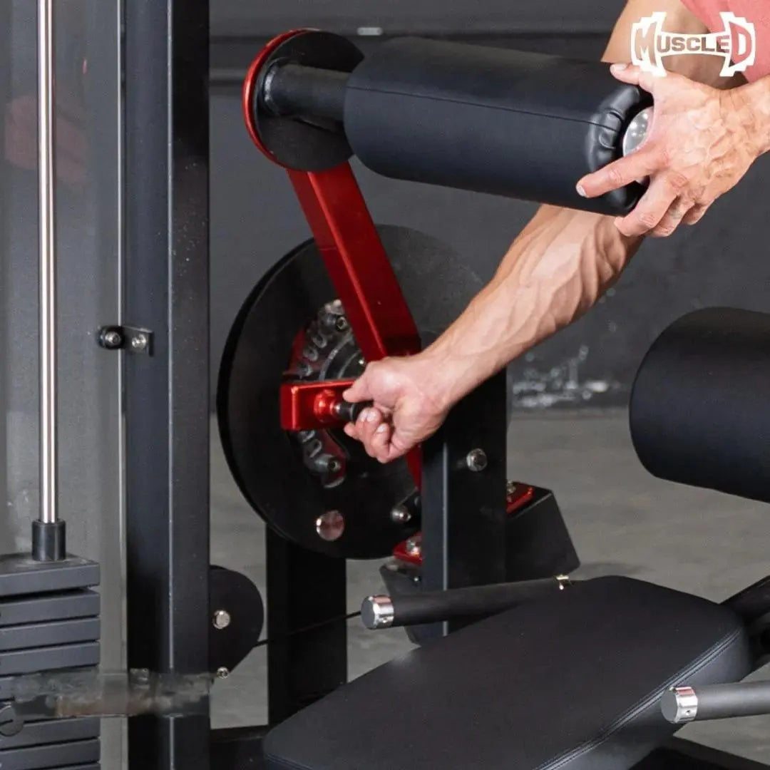 Man using a selectorized back and ab machine with red lever and black weight stack in a gym setting.