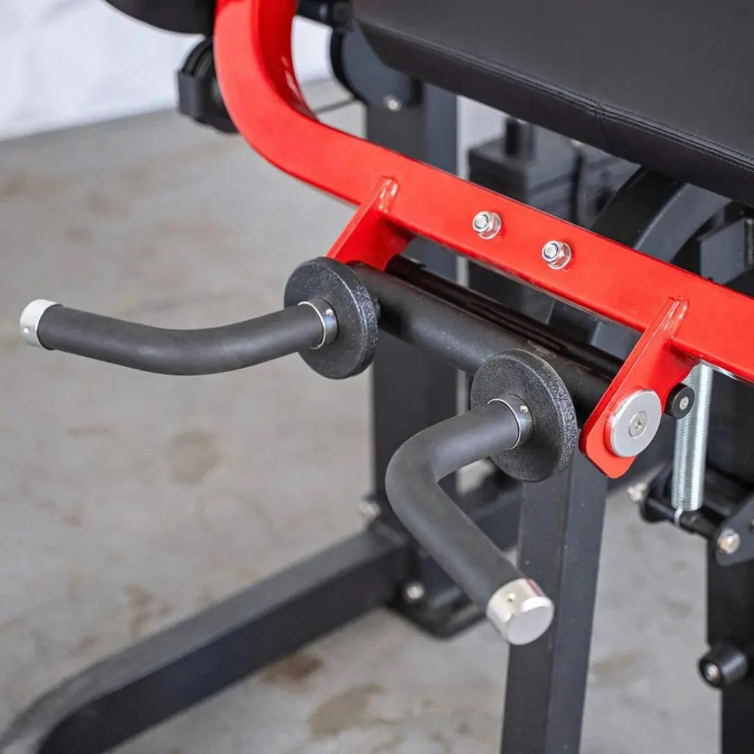 Close-up of red and black biceps-triceps combo machine showing curved handles with textured grip sleeves and adjustment bolts mounted on the frame.
