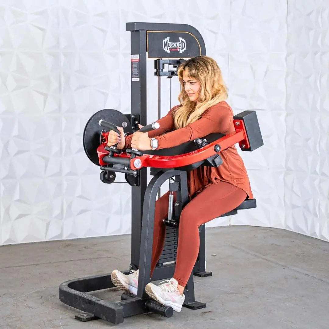 Woman performing a biceps and triceps curl on a red and black selectorized cable machine with weight stack in a gym setting.