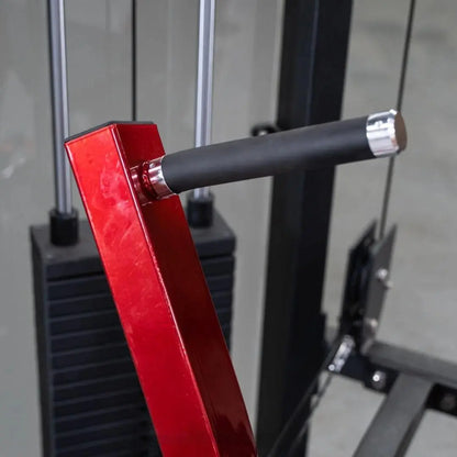 Close-up of a red chest press machine arm with black rubber grip and chrome accents on a commercial selectorized fitness machine.