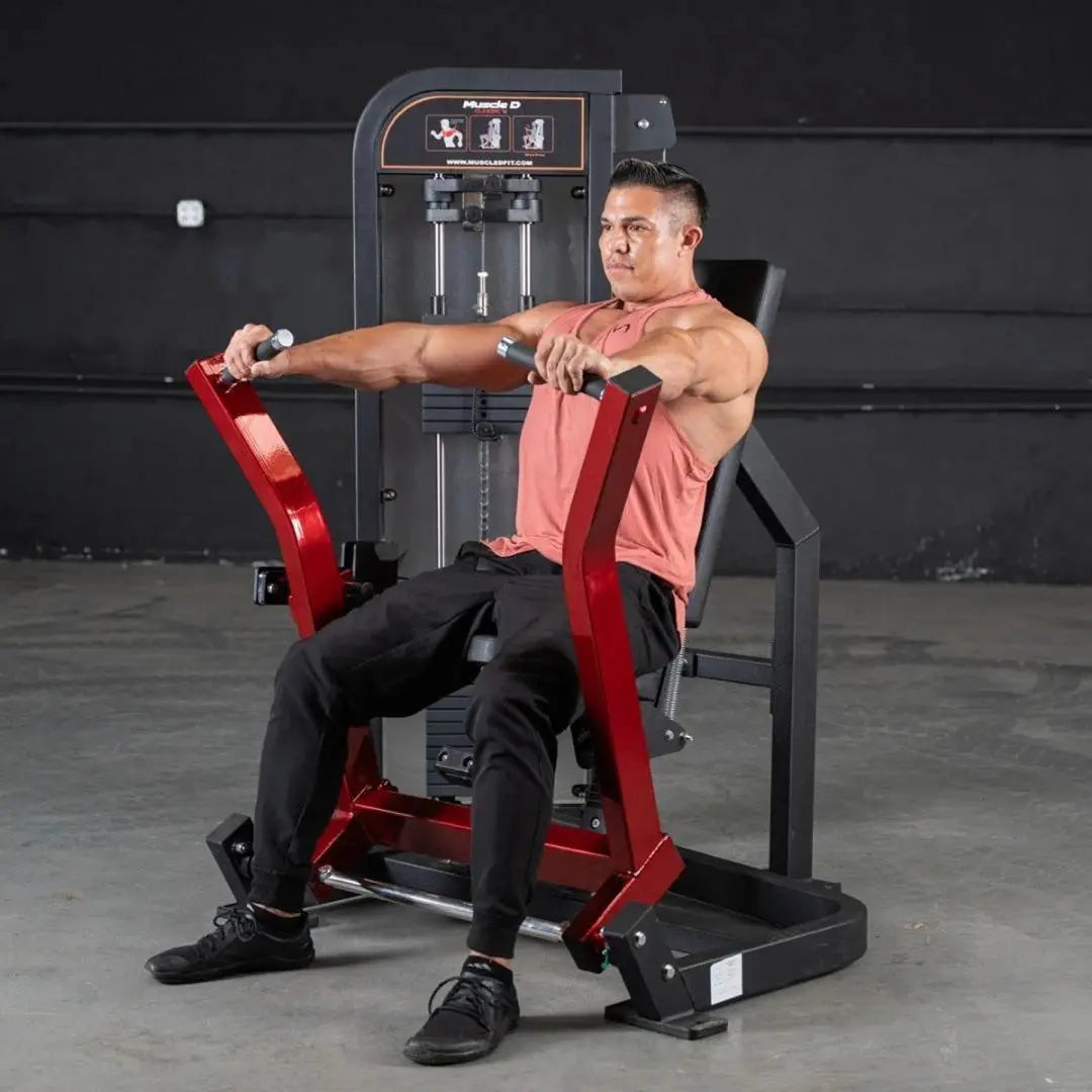 Man performing chest press on a red selectorized chest press machine with black frame and seat in a gym setting.