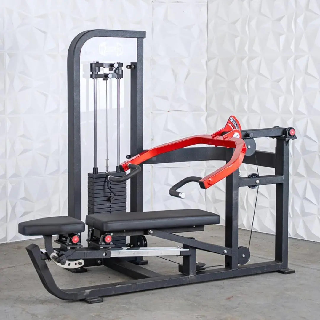 Commercial chest and shoulder machine with black frame, red curved arm attachment, black padded seat and backrest, cable-based resistance system with weight stack on left side, and white textured backdrop.