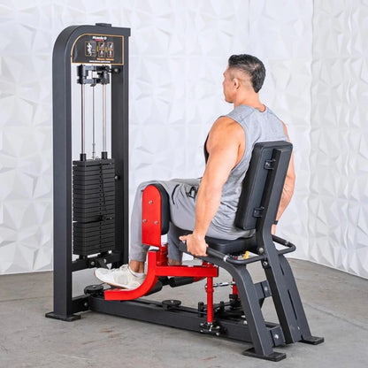 Man performing inner and outer thigh exercise on a black and red selectorized thigh combo machine with weight stack on the left side.
