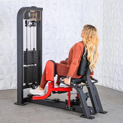 Woman performing inner and outer thigh exercise on a black and red selectorized thigh combo machine with vertical weight stack.