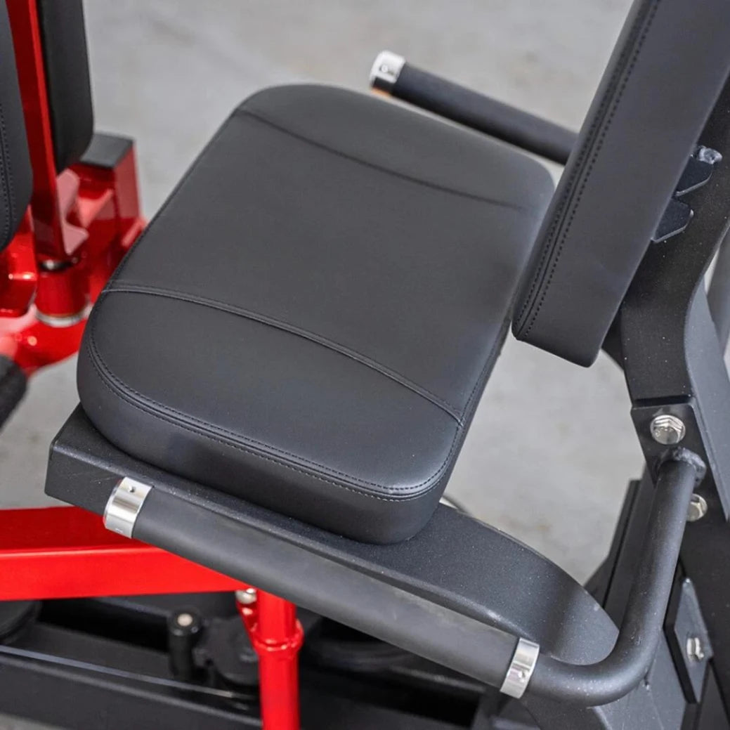 Red and black selectorized thigh combo machine with padded gray leather seat and arm supports, featuring chrome accents and adjustment mechanisms.